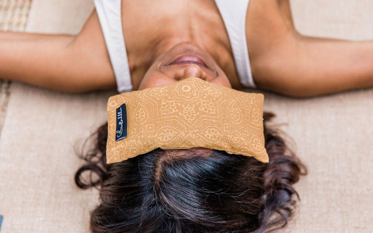 woman meditating with Calm Buddhi Eye Pillow