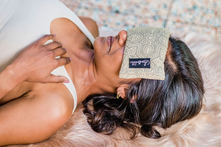 woman using a Calm Buddhi Eye Pillow during yoga nidra